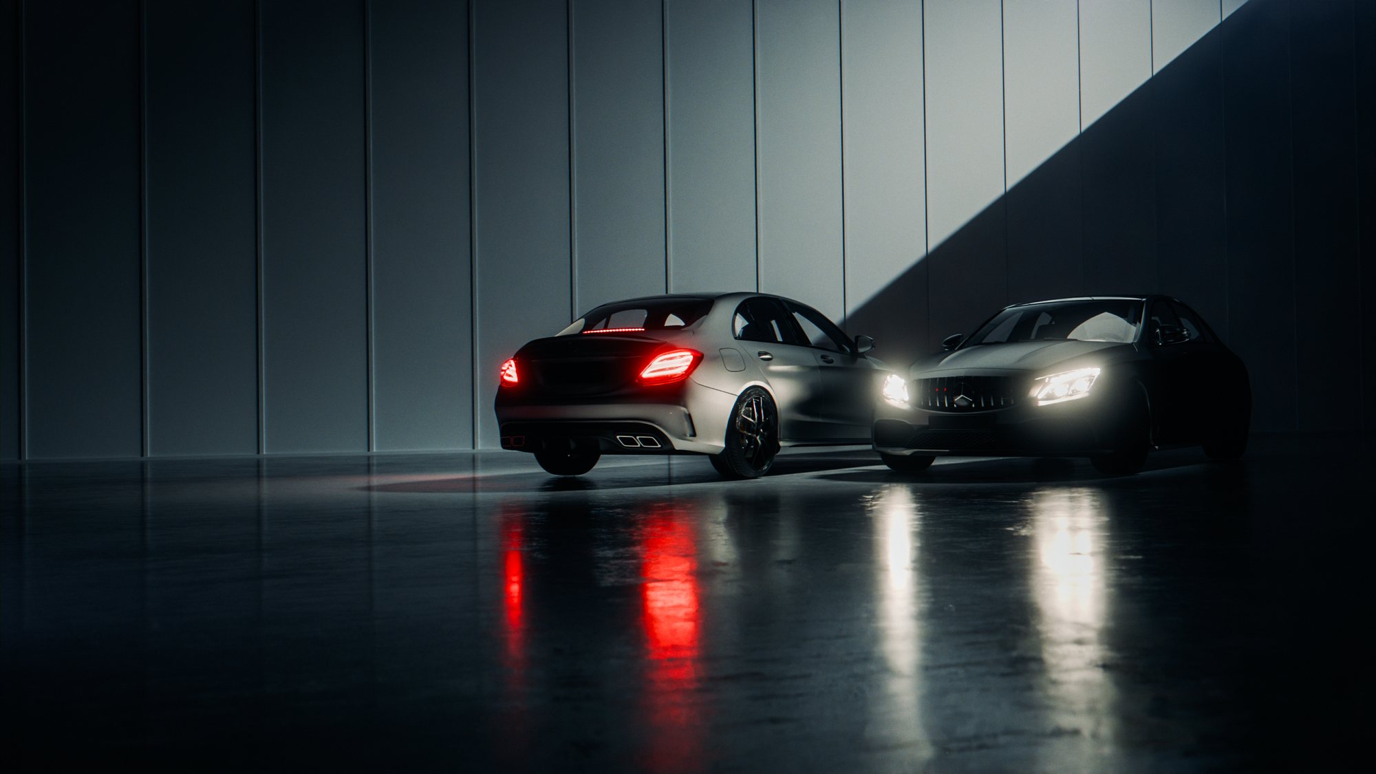 Two C 63 facing each other in the dark underpass, red and white lights on the wet floor