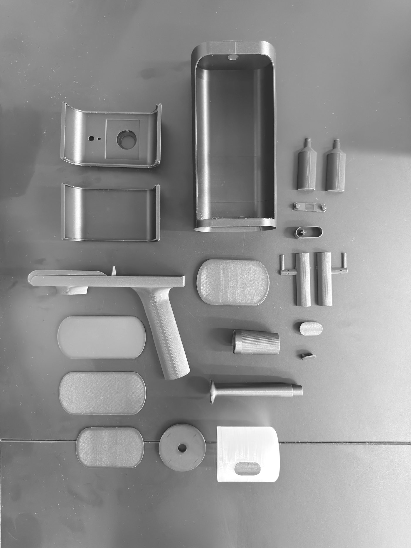 All the printed parts of the prototype laid out on a table